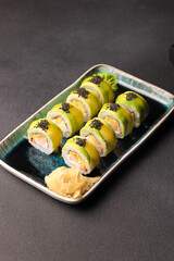 Assorted sushi nigiri and maki big set on slate. A variety of Japanese sushi with tuna, crab, salmon, eel and rolls. Top view