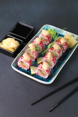 Assorted sushi nigiri and maki big set on slate. A variety of Japanese sushi with tuna, crab, salmon, eel and rolls. Top view