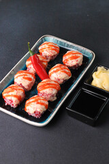 Assorted sushi nigiri and maki big set on slate. A variety of Japanese sushi with tuna, crab, salmon, eel and rolls. Top view