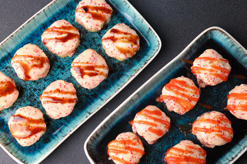 Assorted sushi nigiri and maki big set on slate. A variety of Japanese sushi with tuna, crab, salmon, eel and rolls. Top view