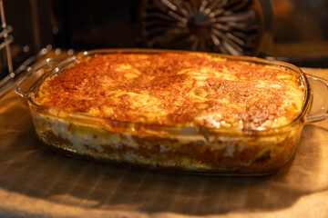baking self made Italian lasagne, with mozzarella in the oven