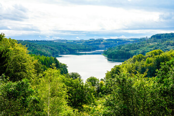 View of the Wiehltalsperre and the surrounding green nature. Idyllic landscape by the lake in the...