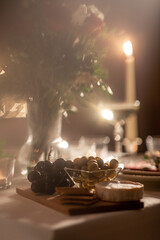 table serving with food, flowers and candles