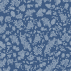 Blue seamless pattern with white floral silhouettes. Simple scattered repeat pattern