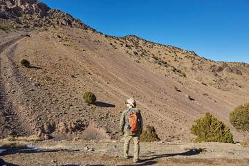 A tourist stands on the Atlas Mountains pass