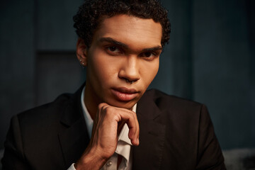 appealing good looking african american male model in elegant suit posing and looking at camera