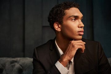 appealing good looking african american male model in evening attire posing and looking away