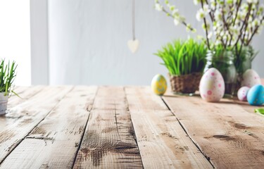 Perspective of table in light colored wooden, some eggs laying on the table surface, blurred background of kitchen or dining room for easter card, celebration of holiday. Beautiful banner.