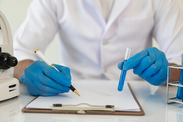 Laboratory concept: Close-up of chemicals in a laboratory, a biochemist is conducting experiments...