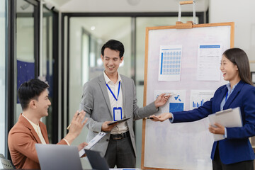 Team of successful Asian businessmen in suits working in conference room to discuss brainstorming,...