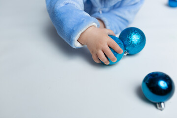 small children's pen on a large Christmas tree toy. Christmas decor in children's hands