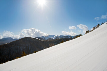 View of a beautiful ski slope on the mountaintop. Marsicano Mounts,, Pescasseroli, Italy.