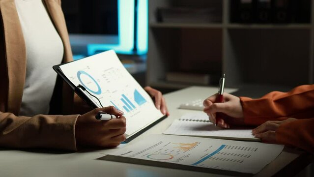 Businessman is reviewing monthly sales documents for analysis and marketing plans for more sales growth, they are the founders of young companies co-founding startups. Sales management concept.