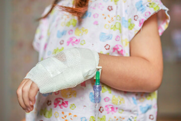 Close up child hand with saline IV solution in hospital