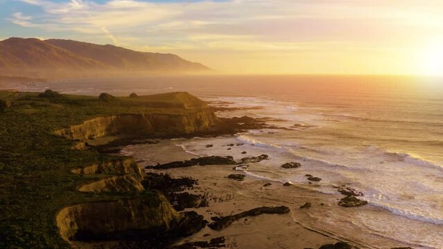 Coastline landscape at sunset with big waves. Aerial view of California Coastline along the Big Sur. 