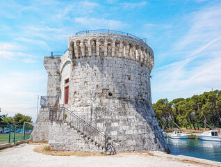 Fototapeta na wymiar Castle tower against the blue sky. Medieval castle tower. Trogir. Croatia.