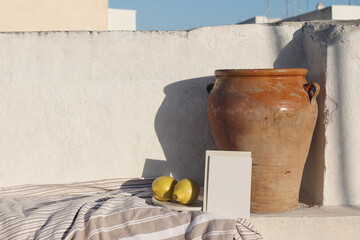 Summer holiday still life. Blank greeting card, invitation mock up in sunlight. Vintage olive clay...