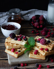Hungarian waffles with berries on a wooden background. Breakfast. Dessert
