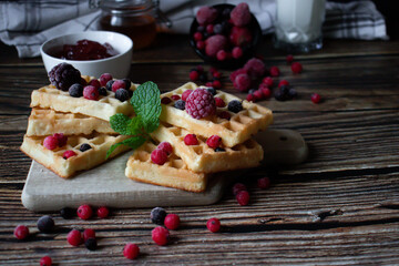 Hungarian waffles with berries on a wooden background. Breakfast. Dessert