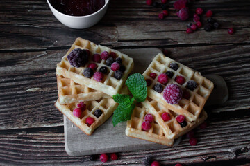 Hungarian waffles with berries on a wooden background. Breakfast. Dessert