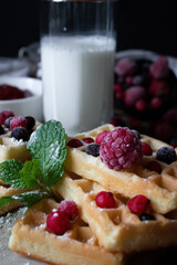 Hungarian waffles with berries on a wooden background. Breakfast. Dessert