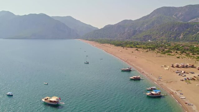 Drone shooting on the beach and down to the sea. Beaches and people swimming in the sea in summer. &Ccedil;ıralı, Antalya coast in the summer of 2023. 4K coast and beach shots