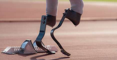 Disabled athletes with running blade used for short races on a running track.