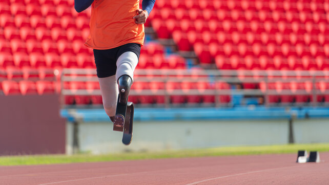 Athletes with disabilities who utilize running blades for short distances. Run down the running track.