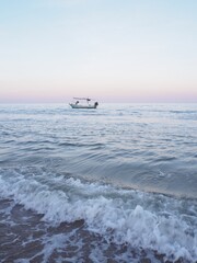 A fishing boat is moored in the middle of the sea.