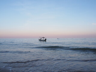 A fishing boat is moored in the middle of the sea.
