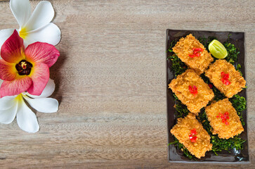 Deep fried chicken topped fried sliced red onion