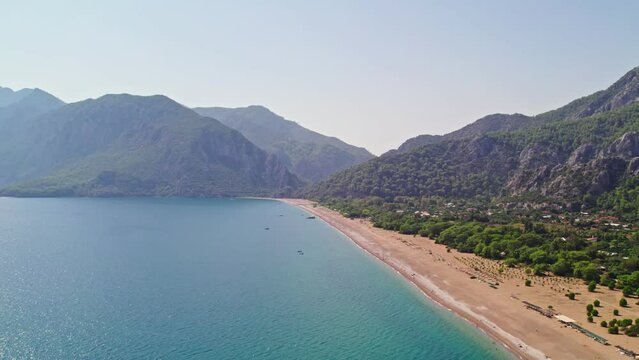 Drone shooting on the beach and down to the sea. Beaches and people swimming in the sea in summer. &Ccedil;ıralı, Antalya coast in the summer of 2023. 4K coast and beach shots