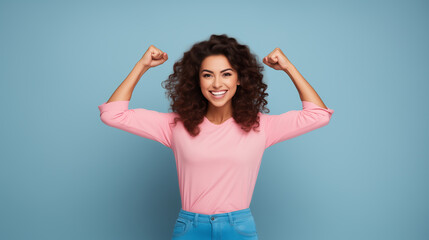 strong woman dressed in pink smiling on a light blue background showing her muscles  - obrazy, fototapety, plakaty