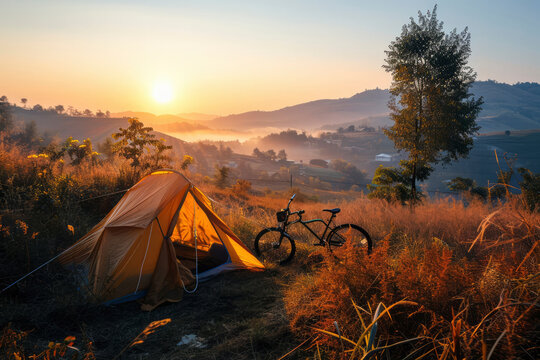 Mountain biking and tent camping in nature at sunset