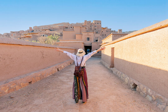 Happy tourist with open arms at Ait Ben Haddu Marocco beautiful place to visite in morocco