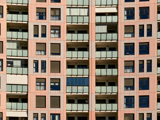 Fototapeta na wymiar Tall housing blocks with a large number of windows and terraces. Singular buildings.