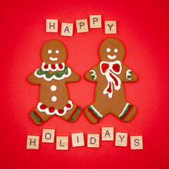gingerbread man and christmas cookies on a red background Happy Holidays wording