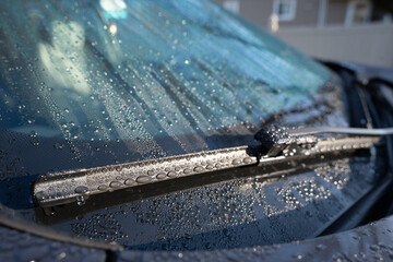 Close up of water drops on a car windshield and windshield wipers - obrazy, fototapety, plakaty