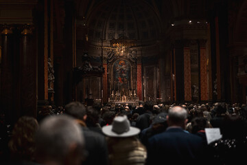 Experience moments of devotion as individuals sit along the church aisle for a service in London. The unity of worshipers creates a serene atmosphere filled with shared faith.