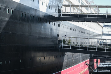 Partial view of superstructure and hull of famous tourist destination and historic ocean liner...