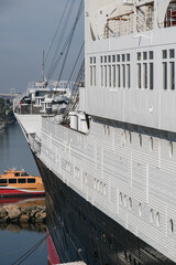 Partial view of superstructure and hull of famous tourist destination and historic ocean liner cruiseship cruise museum ship hotel in port of Long Beach, California USA