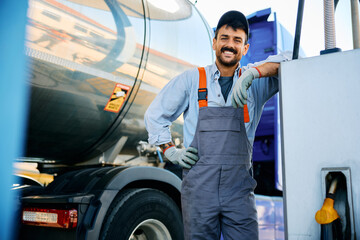 Portrait of happy truck mechanic at work looking at camera.