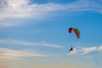 Fototapeta na wymiar Paraglider is flying in the sky