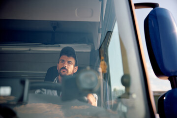 Professional truck driver on road.