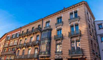 Facades of buildings on trinity square in Toulouse in Occitanie, France