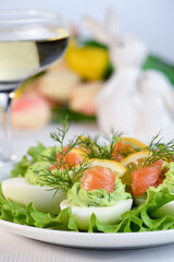 Eggs stuffed with avocado, salmon and lemon. Easter eggs. The perfect appetizer for your holiday table.