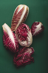 Italian bitter red radicchio chicory from Treviso (PGI, Verona, Italy) on the green background. Mediterranean food concept. Rare vegetables from classic Italian cuisine