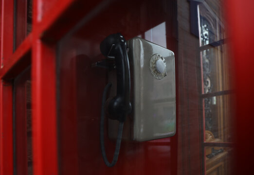 Old street. red phone booth Soviet times. Front view of old Russian public phones. Telephone of the Soviet union with a disk phone. text in Russian: ambulance, fire brigade, police, gas service,