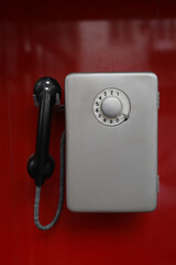 Old street. red phone booth Soviet times. Front view of old Russian public phones. Telephone of the Soviet union with a disk phone. text in Russian: ambulance, fire brigade, police, gas service,