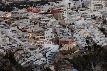  Illuminated balcony decks and patios with restaurants of Fira town on Santorini island. Cyclades,...